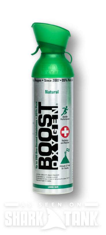 Boost Oxygen natural canister with a green nozzle, silver body, placed against a black background; Shark Tank logo at bottom.